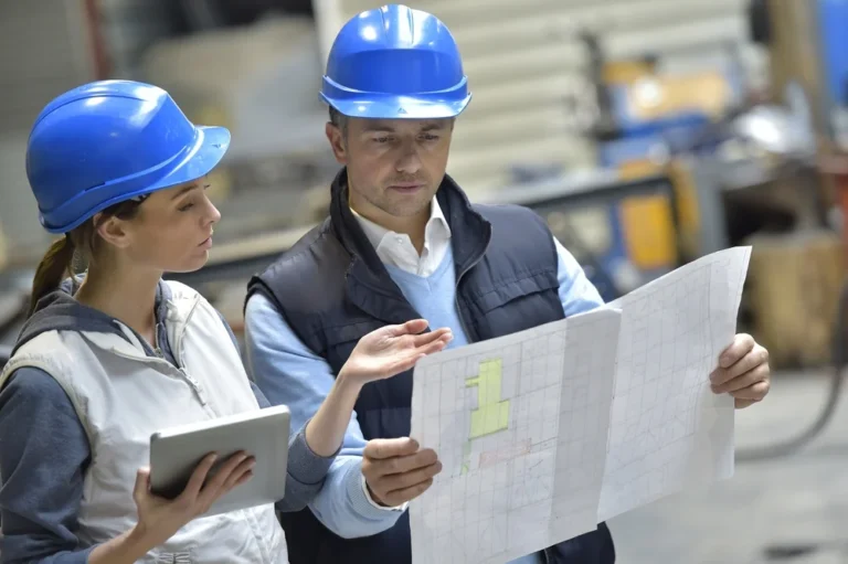 engineers in mechanical factory reading instructions 768x511