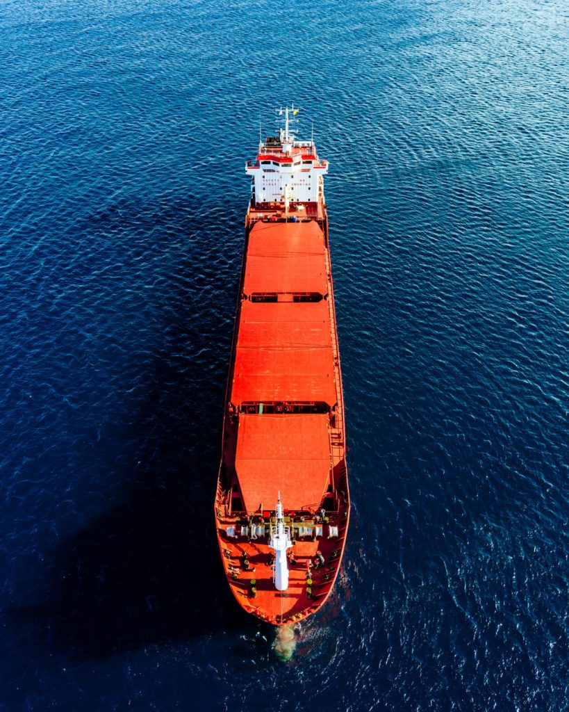 aerial view of general cargo ship in blue sea. view from above o